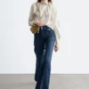 Jeans a zampa con piega a pressione