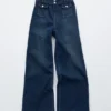Jeans a zampa con piega a pressione