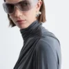 Top a collo alto drappeggiato